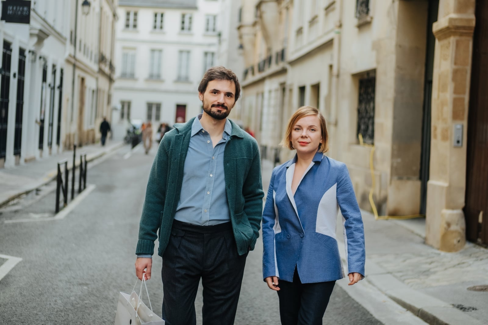 Couple walking through a calm Parisian street, exploring on foot