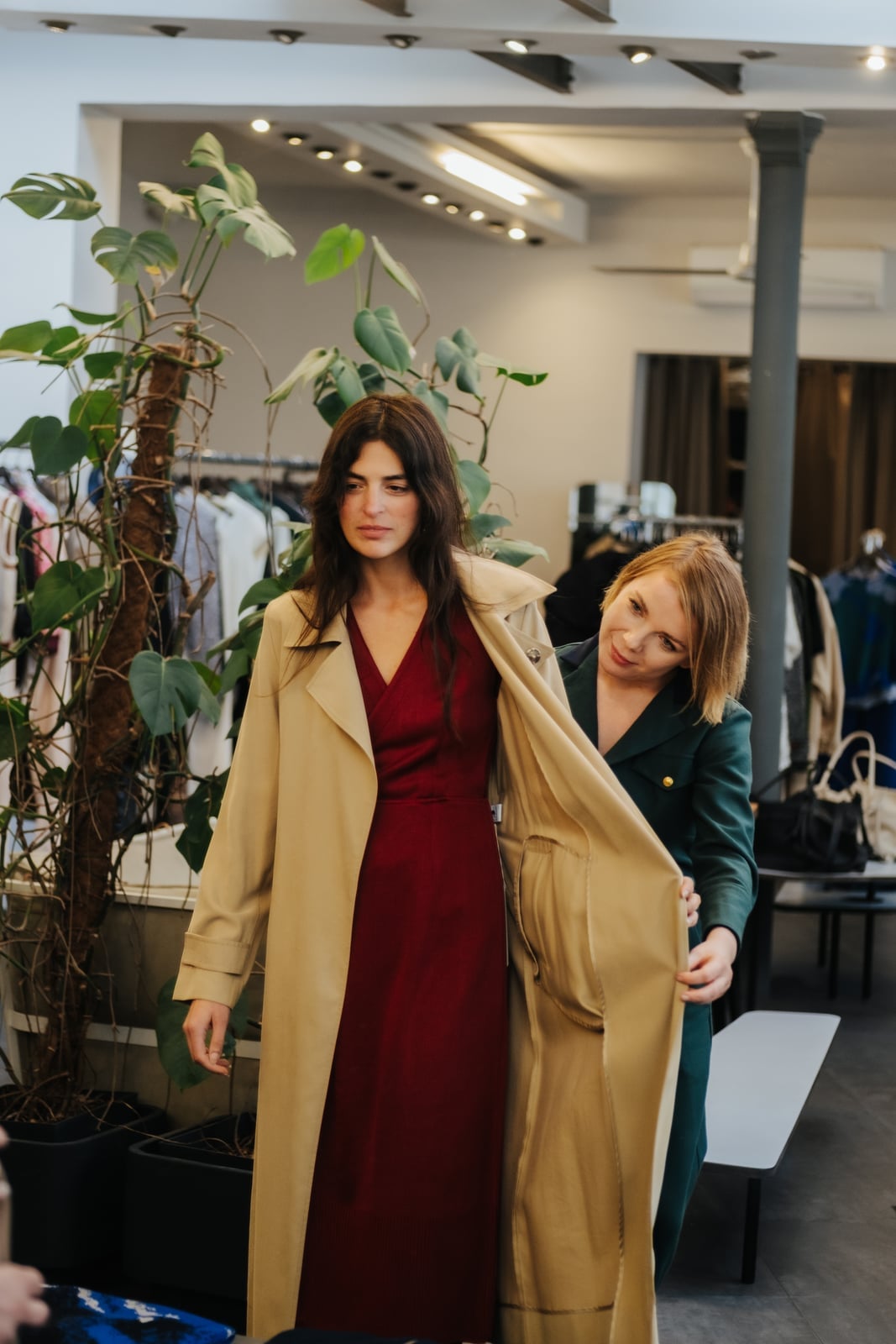 A client being styled in a warm burgundy dress during a personal color analysis session